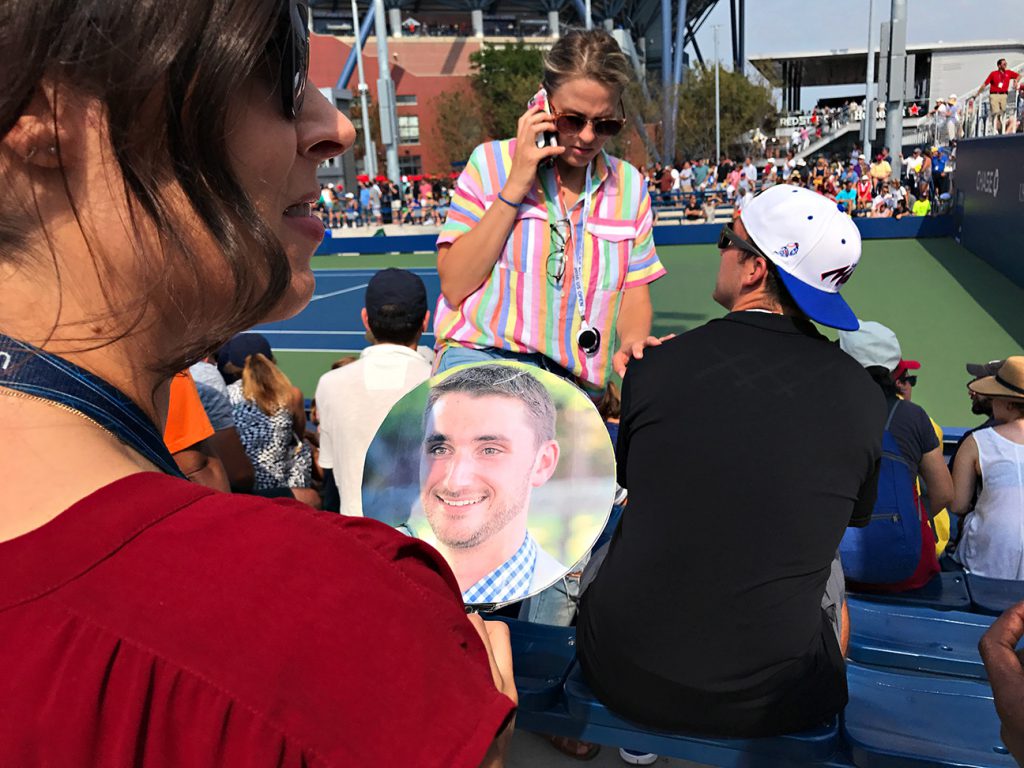 NEW YORK, NY - SEPTEMBER 10:  USTA employees (jena in red) and Lisa (black dress) hold a fan made with a photo of former USTA employee and coworker Jeremy Fehrs during Day Thirteen of the 2016 US Open at the USTA Billie Jean King National Tennis Center on September 10, 2016 in Queens.  They are taking Jeremy's photo throughout the grounds and sending to him since he loves the tournament. (Landon Nordeman for ESPN)
