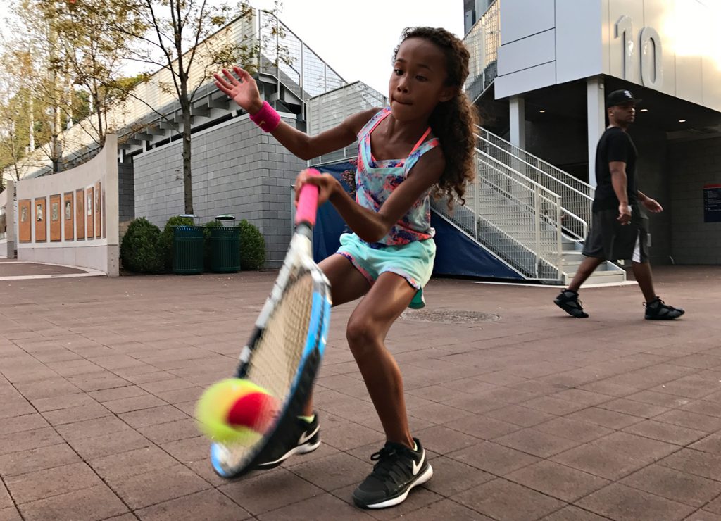 NEW YORK, NY - SEPTEMBER 10:  A young tennis fan Ligaya Murray, 8, from Yonkers, NY plays with her family who are big tennison the grounds during Day Thirteen of the 2016 US Open at the USTA Billie Jean King National Tennis Center on September 10, 2016 in Queens.  (Landon Nordeman for ESPN)