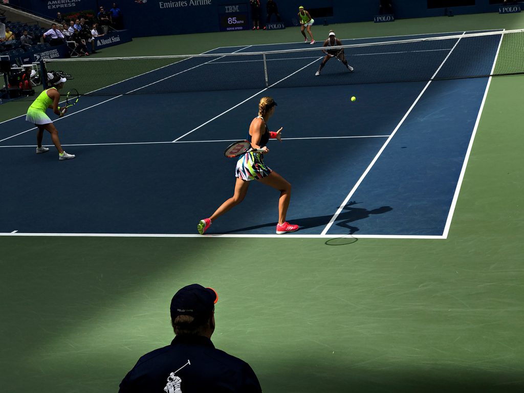 NEW YORK, NY - SEPTEMBER 11:  Caroline Garcia (FRA) and Kristina Mladenovic (FRA) serve to Bethanie Mattek-Sands (USA) [12] and Lucie Safarova (CZE) [12] during the women's doubles finals in Arthur Ashe as the roof casts a shadow across the court on Day 14 of the 2016 US Open at the USTA Billie Jean King National Tennis Center on September 11, 2016 in Queens.  (Landon Nordeman for ESPN)